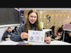 Mount student Michelle Bijak '27 shows off the pretty card she made for Operation Smile.