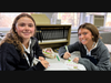 From left, Mount St. Dominic Academy students Olivia Kirkland '28 and Joanna Bellino '28 enjoy spending time together while decorating cards for Operation Smile.