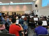 Associate Conductor Ben Nadel is rehearsing with Metea Valley HSSO.