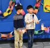 Woodmont Elementary School students Alex Ahn (2nd grade 2) and Ethan Ahn (4th) shared wise words and South Korean Proverbs with their classmates at the 15th Annual Woodmont Giving Day events. 