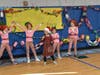 2nd grade singers Clare Glodde, Catherine Glodde, Mackenzie Martinez, Kaylee Kulik and Simone Singer share cheer. 