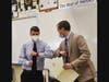 Montville Township High School Principal Douglas Sanford (right) elbow-bumped Morris County Teacher of the Year Christopher Butchko (left) during presentation of a NJ Certificate of Commendation.