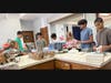 Youth serving food with mentor Zein Bertacchi to raise funds