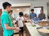 Anthony Zhu, Paari and Varun Dhanasekaran, Sophia Genega and Dimitri Diyadawagamage raising funds by selling food.