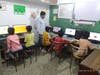 Children using the computer center in the slums of Delhi, India
