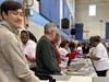 Victor Griffith serving food with his grandparents