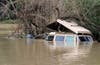 The Russian River settles back within its banks Friday, March 1, 2019, claiming this vehicle in Guerneville, CA.