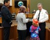 Samantha Barnhouse, with her daughter, receives the Carnegie Hero award from ConFire Chief Jeff Carman, March 12, 2019.