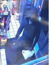 The knife-wielding, masked suspect in at least five armed robberies in Vacaville, CA is shown in a surveillance image.