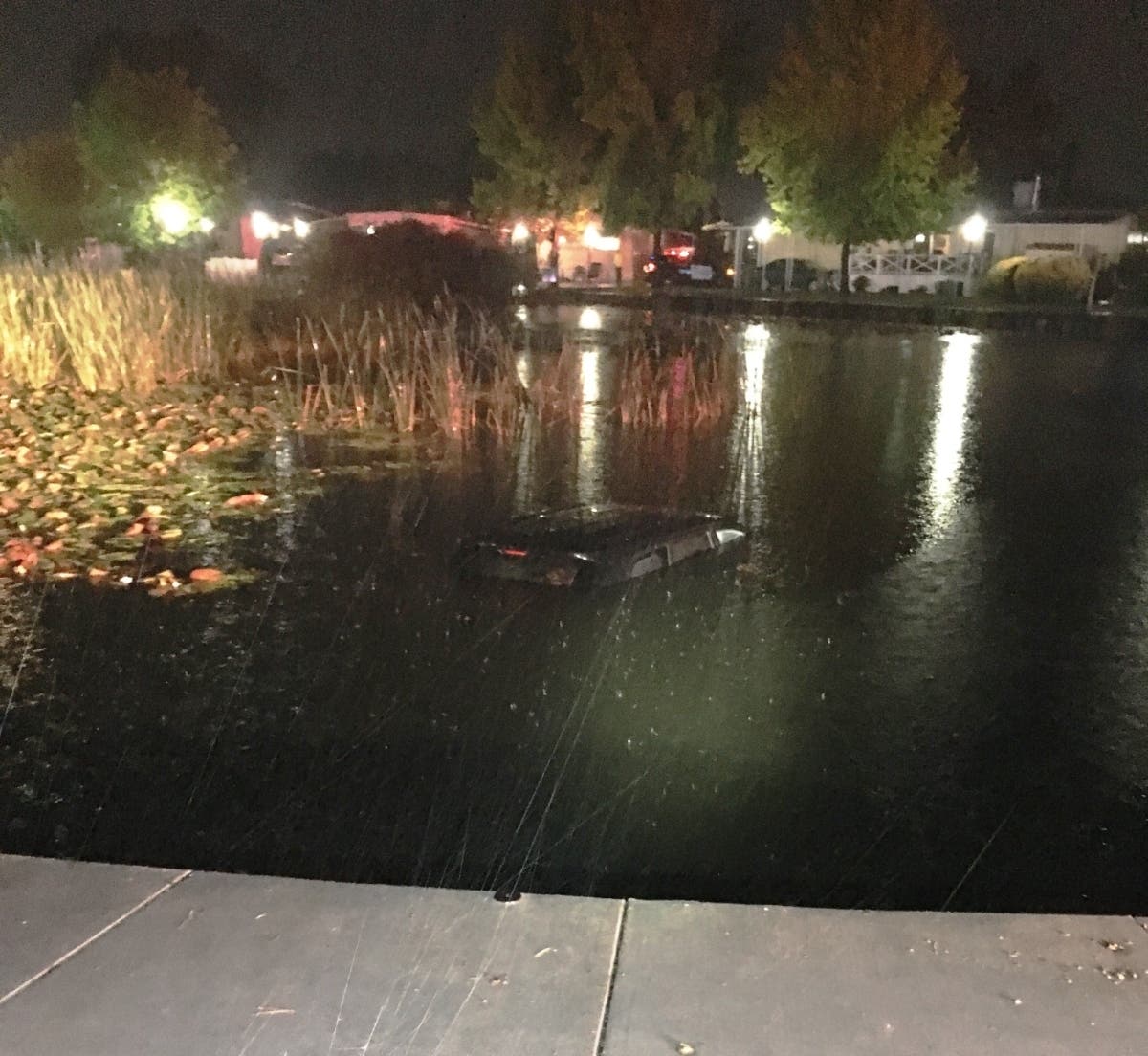A 2018 Jeep Grand Cherokee is shown submerged in a pond in Rohnert Park, California May 18, 2019.