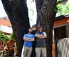 Steve Seybold (right) and Jackson Audley stand at the base of a dying black walnut tree on the 100 block of E St., Davis