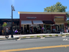 Customers wait in line for the grand opening June 21, 2019 of Cinnaholic at Todos Santos Plaza in Concord, California.