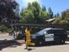 A firefighter rushes past a Rohnert Park police car while responding to a fire near Edgewood Apartments, July 17, 2019.