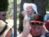 One-year-old Katie Strobel enjoys ice cream served by mom Raelynn, while perched on dad Raymond's shoulders during Napa's annual PorchFest Sunday, July 28, 2019. The family from Napa was among thousands who attended the event.