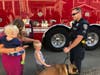 A Benicia police officer chats with residents during one of 11 National Night Out neighborhood stops in the California city.