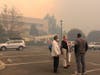 Workers in masks evacuate the main Kaiser Hospital in Santa Rosa during the Tubbs Fire in October 2017.
