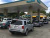 People potentially affected by a fire-weather related PG&E power shutoff in Northern California line up at a Sonoma County gas station to fill their gas tanks and even some containers, Oct. 8, 2019.