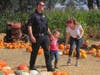 While on a break from work, Napa police Officer Nathan Kistner meets his daughter, 4-year-old Sage, along with Jessie Critchlow, at the Stanly Pumpkin Patch in south Napa.