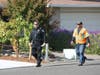 A Healdsburg police officer and a Healdsburg city employee go door to door Saturday, notifying residents of a mandatory evacuation order.