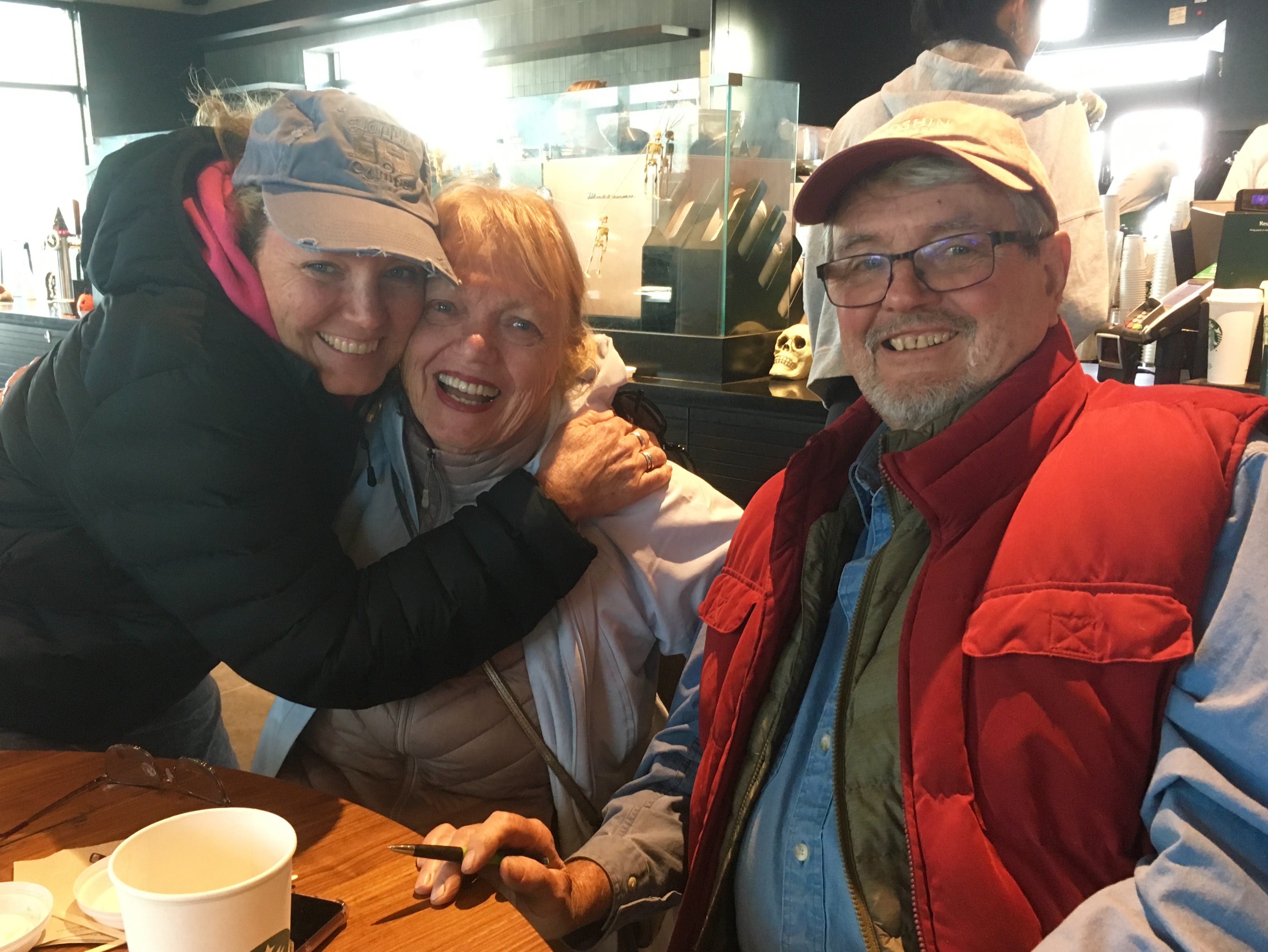 Kincade Fire evacuees Michelle Holden (left) and her parents, Pat and Rod Larrick of Larrick Vineyards in Healdsburg, enjoy some coffee at Starbucks in Rohnert Park.
