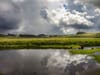 Rain clouds are reflected in a body of water along Spring Hill Road in Petaluma, Californa.