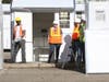 Workers bustle about Wednesday, Jan. 22, 2020, as Sonoma County's emergency temporary shelter for the homeless begins to take shape across from the Oakmont retirement community east of Santa Rosa in the Sonoma Valley.