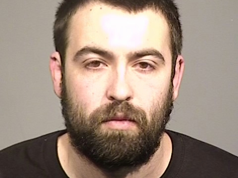 Grocery store employee Kendall Hansen-Keys is shown in a jail booking photo after police say he admitted setting up his phone in an attempt to record a female co-worker he was interested in.