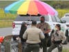 Sonoma County sheriff's deputies speak with a fruit stand worker Saturday near Adobe and Frates roads east of Petaluma.