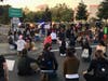 Friday night in Santa Rosa, protesters kneel and sit on Steele Lane at U.S. Highway 101 as a line of California Highway Patrol officers block their entrance to the freeway.