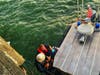 A man whose boat capsized Wednesday in the waters off Rodeo is pulled aboard a U.S. Coast Guard craft.