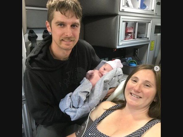 ConFire firefighter Karl Taugher, his wife and their newborn baby girl get an ambulance ride  to the hospital Wednesday after Karl delivered his baby daughter on the side of the road.