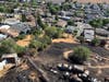 An aerial photo provided by Con Fire shows the extent of fire damage to a Cambark Court home and storage yard, and the proximity of the fire to other homes. Firefighters saved at least 12 surrounding homes in the fire Wednesday in unincorporated Martinez.