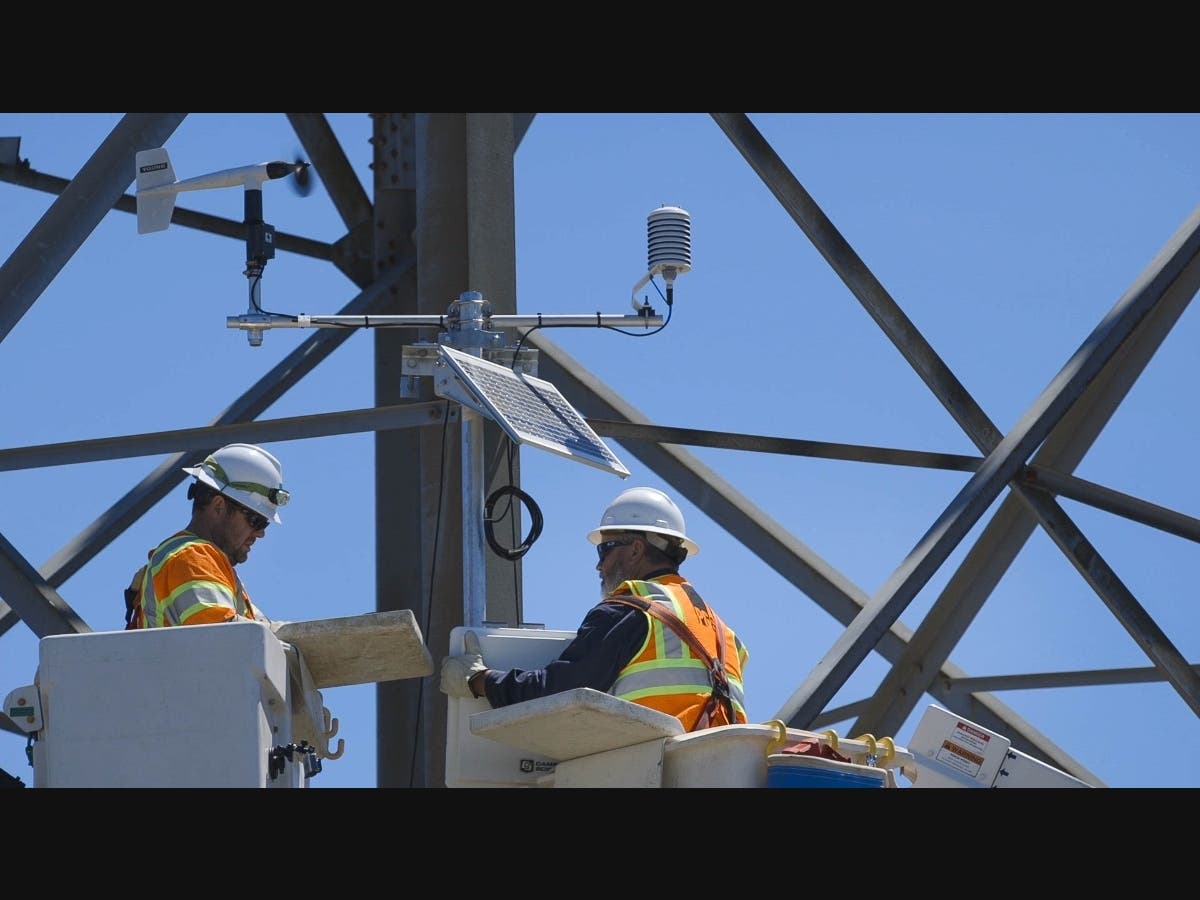 PG&E crew members are shown installing a weather station in the North Bay