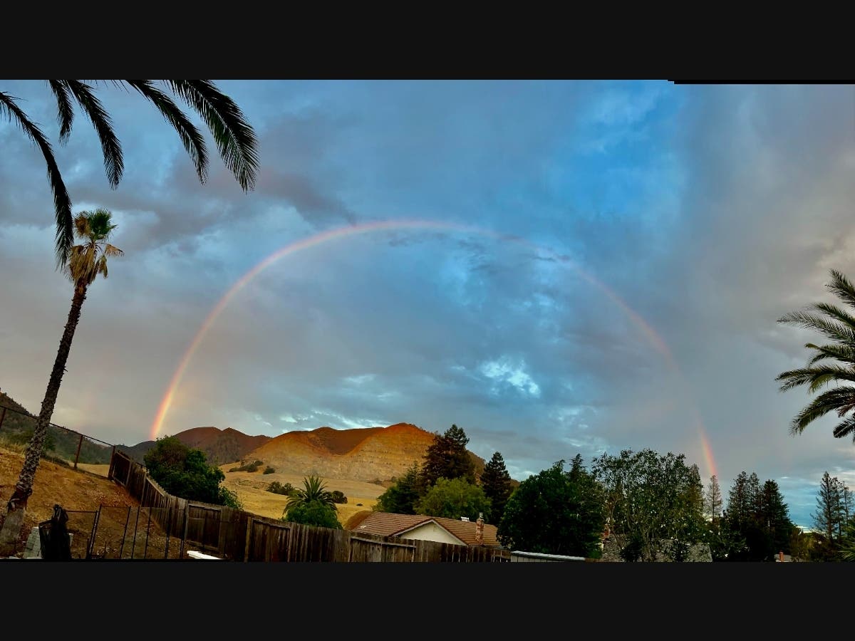 A rainbow shines through as clouds clear over Clayton.