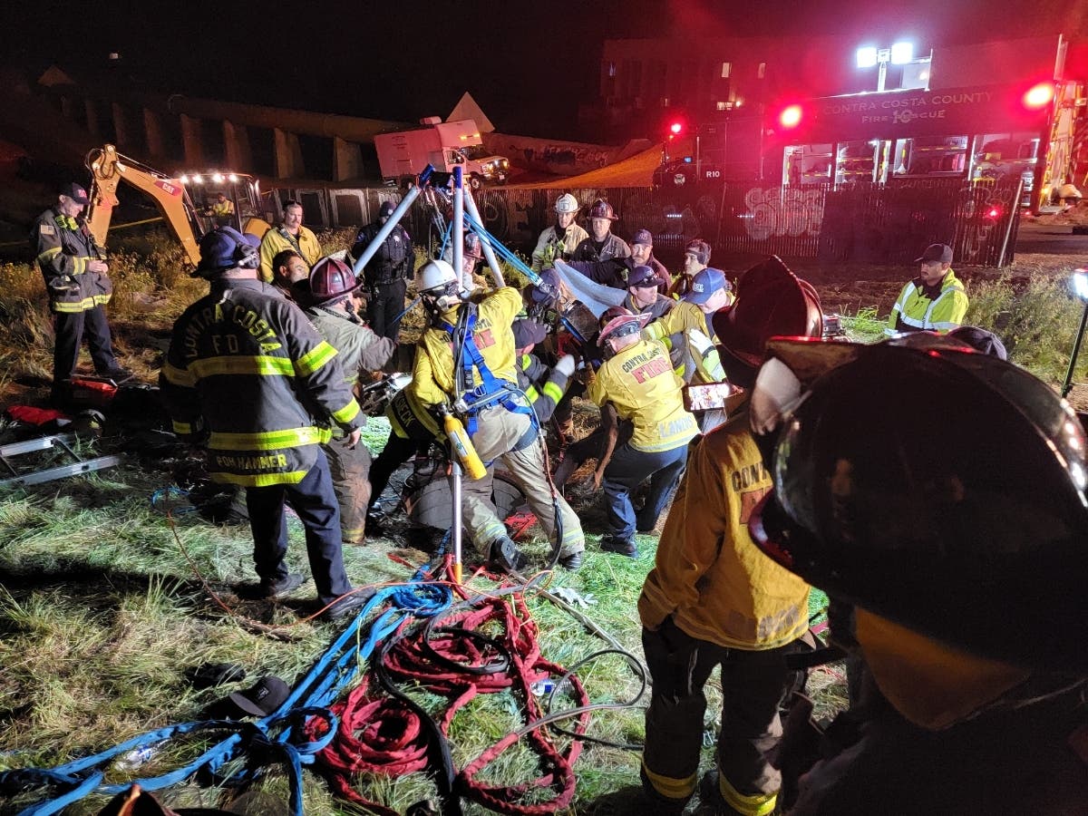 Con Fire firefighters bring a man to the surface Sunday after he was rescued from a drainage pipe in Antioch where he was stuck for two days.