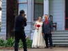 A photographer takes a picture of a newly married couple in front of the John Muir House in Martinez, California.