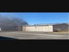 A fire burns Monday inside a private hangar at the Petaluma Airport.