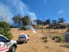 The Pacheco Fire burns close to a structure Thursday in Martrinez.