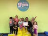 Jill Glassman, Director of The Jerry Davis Center for Children and Families receives the donation from the children of The Little Gym - Montgomery/Hillsborough