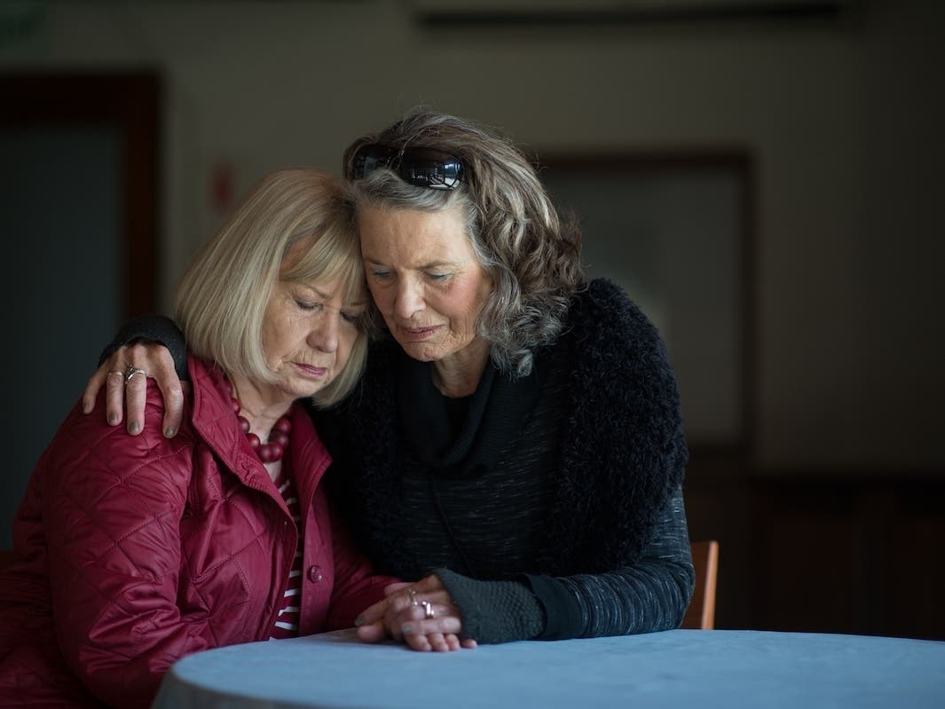 Two senior ladies supporting one another