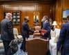 René R. Alba, a Georgia leader of The Church of Jesus Christ of Latter-day Saints shake hands with Governor Kemp in a meeting where he presented the governor with his family history.