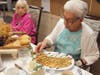 Josephine Rodriguez samples bruschetta flatbread at Peace Village. 