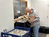 Volunteer Bill Fitzgerald checks that all meals include fruit and milk while packing Home Delivered Meals at Pathlights in Palos Heights. 