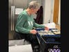 Volunteer Therese McLaughlin packs meals and milk for Pathlights' Home Delivered Meals program. 