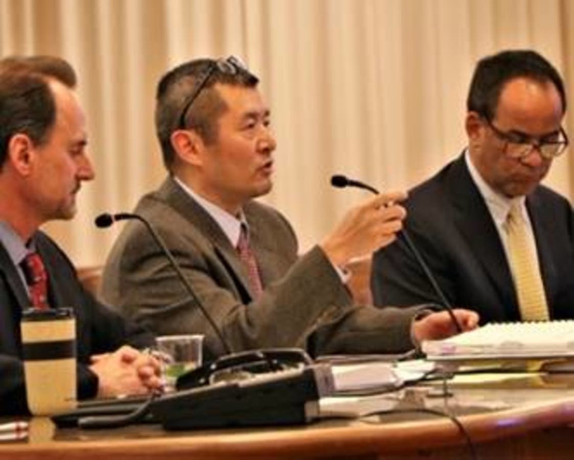 Tom Lai (center) of the Community Development Agency speaks to the Board of Supervisors. 