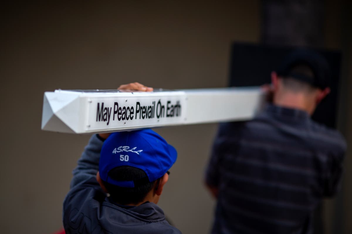 Boys carry peace pole to interfaith prayer vigil at Rancho Bernardo Community Presbyterian Church after Poway synagogue 
