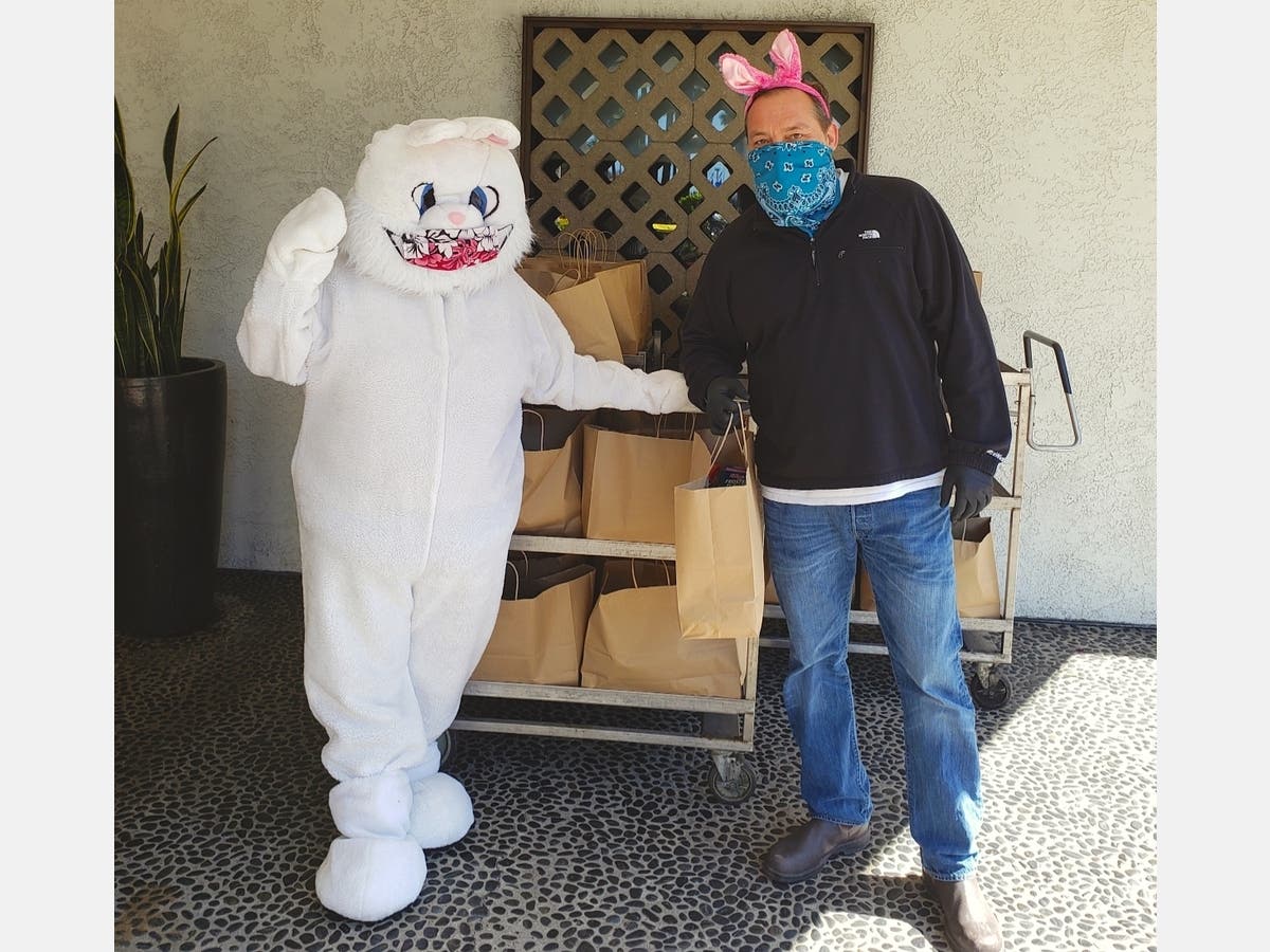 From left: Easter Bunny and Greg Guthrie, Hotel Maya general manager.