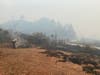 Small fires smolder along Chemise Road in mountains west of Healdsburg during the Walbridge Fire. 