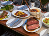 The "Entertaining at Home Menu" is available for to-go over 4th of July weekend at Izzy's in San Francisco and San Carlos.