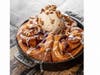 The new "Ultimate Cinnamon Roll," topped with pecan ice cream, is on the New Year's Day brunch menu at Cardellino in Mission Hills, San Diego.